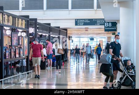 Aurora Colorado USA June 7 2021; Travelers wearing protective masks relax in the Denver International airport as the both leave and arrive from all ov Stock Photo