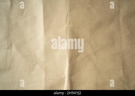 Crumpled Kraft paper with crease in the middle Stock Photo