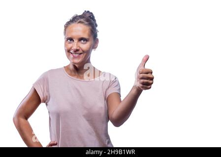smiling adult woman showing thumb up on a white background Stock Photo