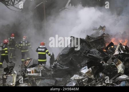 Firefighters try to extinguish a fire that broke out in a clothing ...