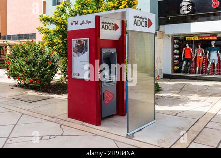 Hurghada, Egypt - May 31, 2021:  ATM Bank ADCB on promenade street of New Marina in Hurghada. Lettering in English and Arabic. Stock Photo