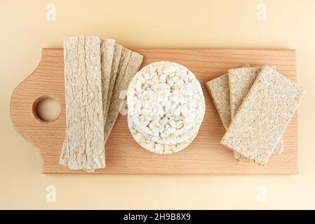 Different types of crispbreads on a wooden board. Stock Photo