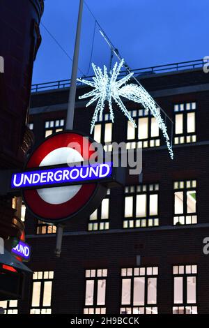 Covent Garden illuminated Underground sign with a shooting star Christmas Light in the background Stock Photo