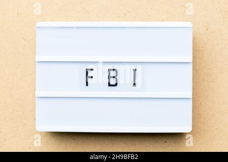 White lightbox with word FBI (Abbreviation of Federal Bureau of Investigation) on wood background Stock Photo