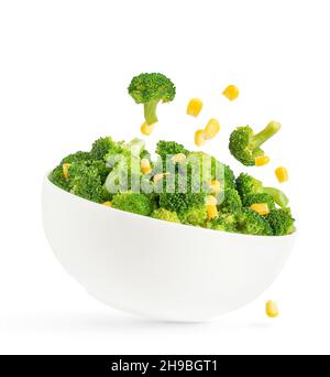 Broccoli salad bowl with flying ingredients isolated on white background. Stock Photo
