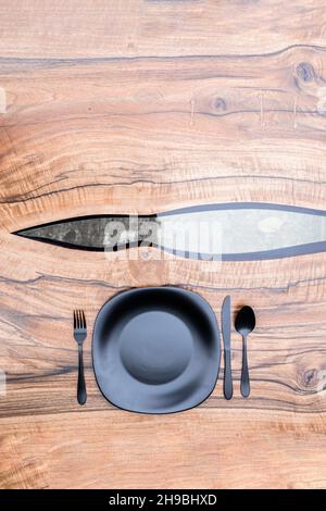Black plate on a elegant epoxy resin table Stock Photo