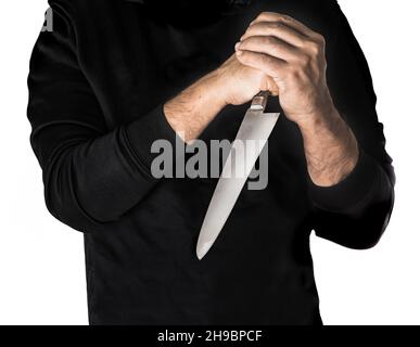 Person in hoodie hairy skin chef holding kitchen knife by two hands white background Stock Photo