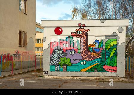 School backyard painted various animals graffiti mural on electrical control cabinet in Sofia Bulgaria, Eastern Europe, Balkans, EU Stock Photo