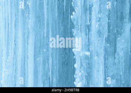 Background of icicles on frozen waterfall wall. Stock Photo