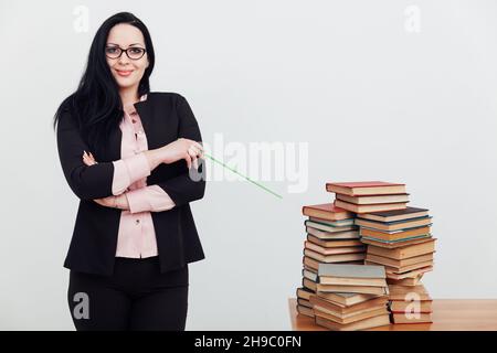 female teacher at the table with books for studying at the university Stock Photo