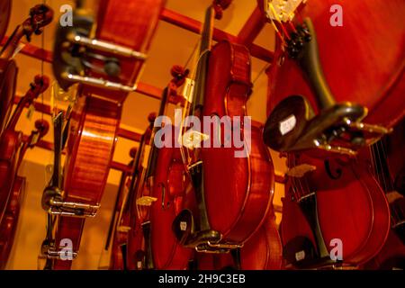 Low angle shot of violins in a music store Stock Photo