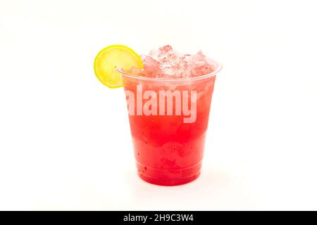 Strawberry iced drink with lemon slice served in to go cup. Stock Photo