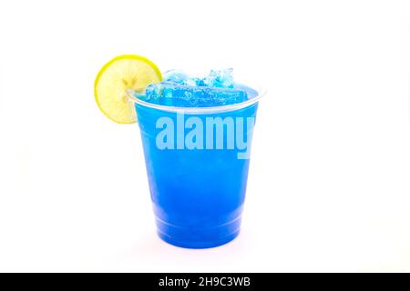 Ice cold electric blue lemonade with a slice of lemon in a disposable cup. Stock Photo