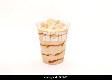 Caramel iced latte served in a disposable coffee cup. Stock Photo