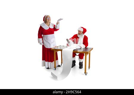 Emotional Santa Claus and his wife, missis Claus congrats with New Year and Christmas, writing a letter, wish list Stock Photo