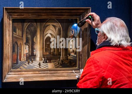 London, UK. 6th Dec, 2021. A visitor examines a work - Preview of Bonhams Old Master Paintings Sale at Bonhams New Bond Street, London. The sale takes place on 8th December. Credit: Guy Bell/Alamy Live News Stock Photo
