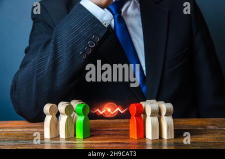 Businessman leader is thinking about resolving conflict of people groups. Rivalry and competition. Resolution, compromise through negotiations. Reconc Stock Photo