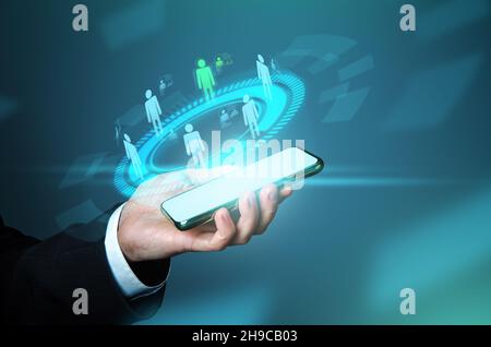 Businessman selects a new employee among candidates on phone. Futuristic hologram, innovative. Staffing, human resources management. Employment. IoT t Stock Photo