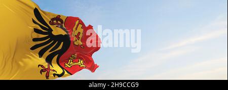 flag of Canton of Geneva , Switzerland at cloudy sky background on sunset, panoramic view. Swiss travel and patriot concept. copy space for wide banne Stock Photo