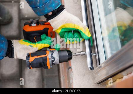 The wizard is engaged in installing windows. Repair work. Stock Photo