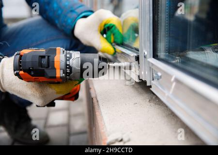 The wizard is engaged in installing windows. Repair work. Stock Photo