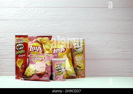 KHARKOV, UKRAINE - JANUARY 3, 2021: Various flavoured of lay's and pringles potato chips in classic packages design. Worldwide famous brands of potato Stock Photo