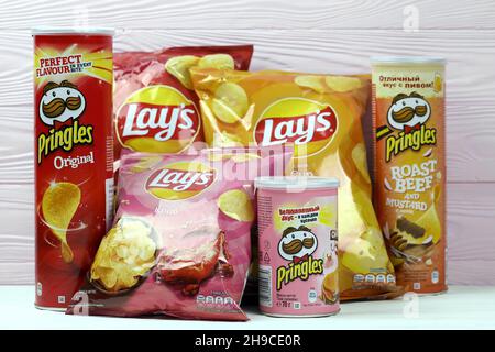 KHARKOV, UKRAINE - JANUARY 3, 2021: Various flavoured of lay's and pringles potato chips in classic packages design. Worldwide famous brands of potato Stock Photo