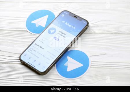 KHARKOV, UKRAINE - MARCH 5, 2021: Telegram Messenger icon and application from App store on iPhone 12 pro display screen on white wooden table Stock Photo