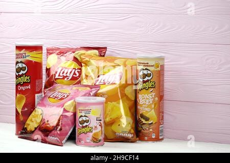 KHARKOV, UKRAINE - JANUARY 3, 2021: Various flavoured of lay's and pringles potato chips in classic packages design. Worldwide famous brands of potato Stock Photo