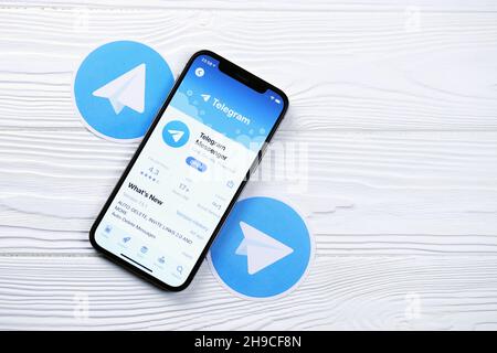 KHARKOV, UKRAINE - MARCH 5, 2021: Telegram Messenger icon and application from App store on iPhone 12 pro display screen on white wooden table Stock Photo