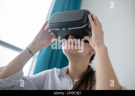 Woman using the wireless virtual reality headset Stock Photo