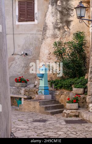 Blue antique water column with faucet. Old vintage water tap in Moscenice. Croatia. Stock Photo