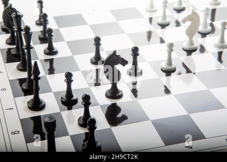 Chess pieces on the chessboard. Intellectual game -chess. Chess pieces on the Board. A game of chess. Not a color image. Black and white. Stock Photo