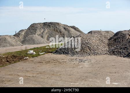 mountains of gravel near the road Stock Photo