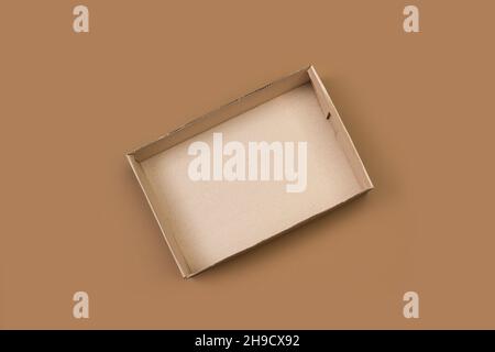 An open cardboard box in a top view on a brown background Stock Photo