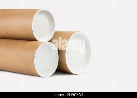 Three cardboard cylinder containers for storage artworks on a white background Stock Photo