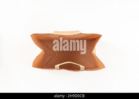 Open paper bag, brown shopping bag on white background. Top view Stock Photo