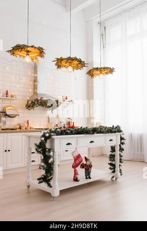 Light kitchen interior with Christmas decor and white wood. Kitchen in classic or Scandinavian style. Stock Photo