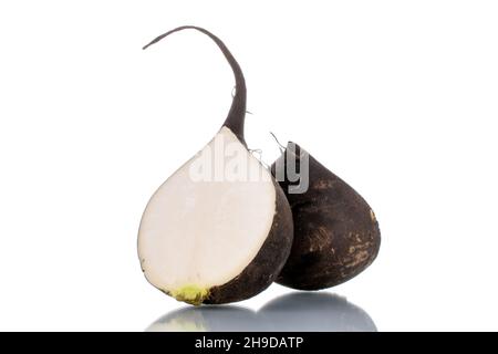 Two halves of ripe juicy black radish, close-up, isolated on white. Stock Photo