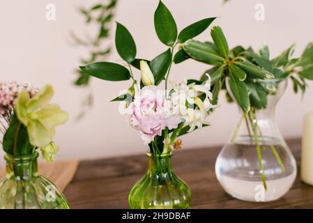 Pink eustoma and white hyacinth flowers in a glass vase in the decor of the house or table Stock Photo
