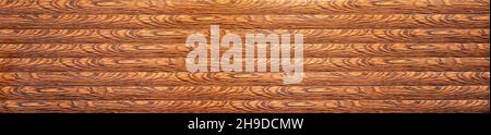 Brown panoramic background with stripes of wood grain. Stock Photo