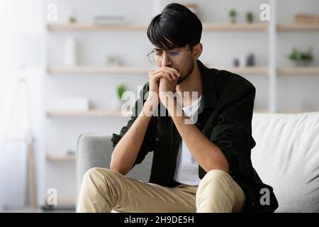 Stressed middle eastern young man suffering from crisis while pandemic Stock Photo