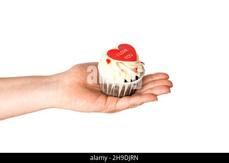 Shaped Heart Cake in the hand with the inscription I Love You on white isolated background. Cupcake in the shape of heart close-up Stock Photo