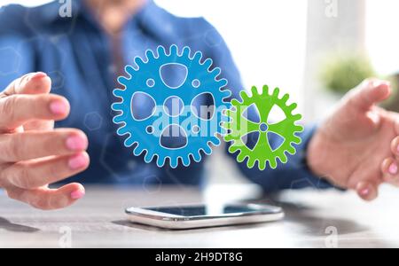 Smartphone with teamwork concept between hands of a woman in background ...