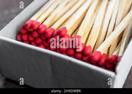 Close up of wooden matches with red sulfur heads. Macro. To light a fire Stock Photo
