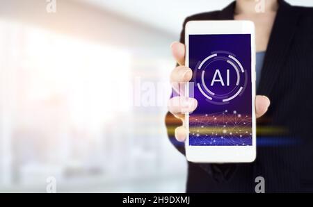 Global database and artificial intelligence. Hand hold white smartphone with digital hologram Artificial intelligence sign on light blurred background Stock Photo