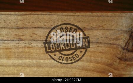Lockdown stamp printed on wooden box. Closed business during the pandemic, quarantine and stay home concept. Stock Photo