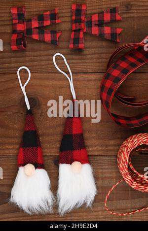 Christmas Flat Lat - an arrangement of Gnome ornaments and bows in black and red plaid with ribbon and twine. Stock Photo