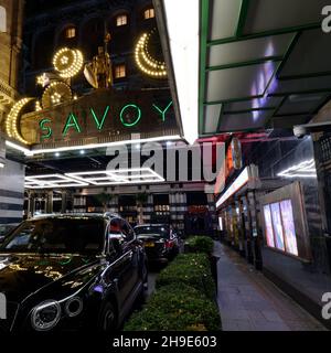 London, Greater London, England, December 04 2021: Taxi Rank and Entrance to The Savoy at Christmas time at night. A luxury hotel on The Strand. Stock Photo