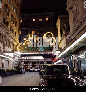 London, Greater London, England, December 04 2021: Taxi Rank and Entrance to The Savoy at Christmas time at night. A luxury hotel on The Strand. Stock Photo